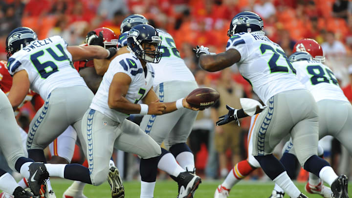 August 24, 2012; Kansas City, MO, USA; Seattle Seahawks quarterback Russell Wilson (3) hands off to running back Michael Robinson (26) in the first quarter of the game against the Kansas City Chiefs at Arrowhead Stadium. Mandatory Credit: Denny Medley-Imagn Images August 24, 2012; Kansas City, MO, USA; Seattle Seahawks quarterback Russell Wilson (3) hands off to running back Michael Robinson (26) in the first quarter of the game against the Kansas City Chiefs at Arrowhead Stadium. Mandatory Credit: Denny Medley-Imagn Images