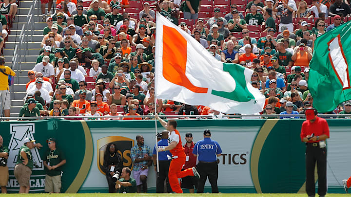 Sep 28, 2013; Tampa, FL, USA; Miami Hurricanes cheerleader runs across the field with a 'U" flag during the first half against the South Florida Bulls at Raymond James Stadium. Mandatory Credit: Kim Klement-USA TODAY Sports