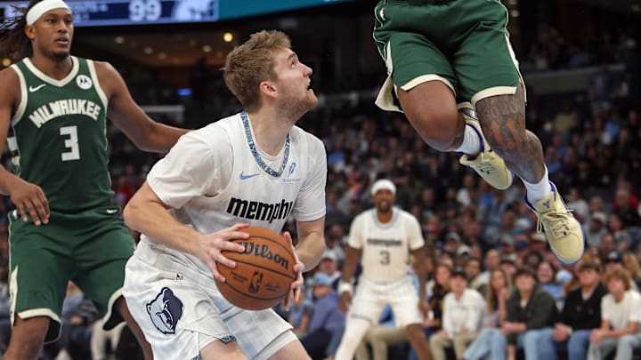 Dec 26, 2025; Memphis, Tennessee, USA; Memphis Grizzlies guard Cam Spencer (24) pump fakes Milwaukee Bucks guard Ryan Rollins (13) during the fourth quarter at FedExForum. Mandatory Credit: Petre Thomas-Imagn Images