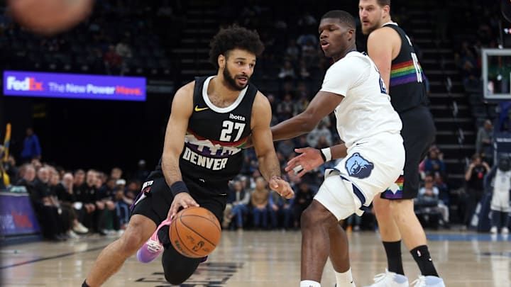 Nov 24, 2025; Memphis, Tennessee, USA; Denver Nuggets guard Jamal Murray (27) drives to the basket as Memphis Grizzlies forward Cedric Coward (23) defends during the first quarter at FedExForum. Mandatory Credit: Petre Thomas-Imagn Images