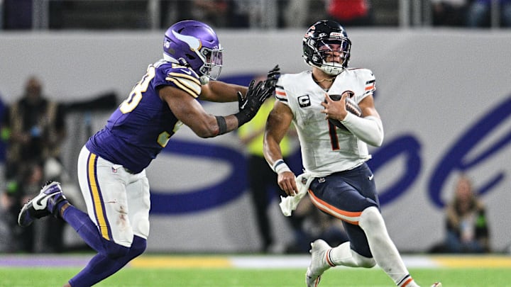 Nov 27, 2023; Minneapolis, Minnesota, USA; Chicago Bears quarterback Justin Fields (1) is tackled by Minnesota Vikings linebacker D.J. Wonnum (98) during the game at U.S. Bank Stadium. Mandatory Credit: Jeffrey Becker-Imagn Images