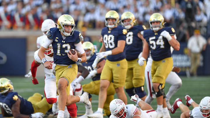 Sep 21, 2024; South Bend, Indiana, USA; Notre Dame Fighting Irish quarterback Riley Leonard (13) runs for a touchdown in the fourth quarter against the Miami Redhawks at Notre Dame Stadium. Mandatory Credit: Matt Cashore-Imagn Images