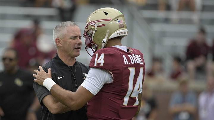 Aug 29, 2026; Tallahassee, Florida, USA;  Florida State head coach Mike Norvell talks with quarterback Ashton Daniels (14) during warmups prior to a game against New Mexico State at Doak S. Campbell Stadium.  Mandatory Credit: Melina Myers-Imagn Images