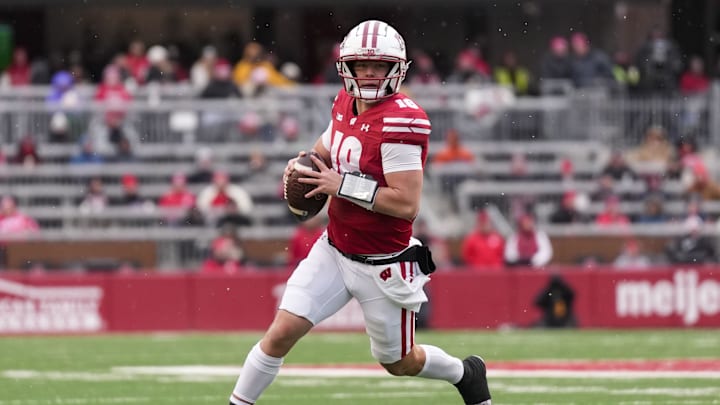 Nov 29, 2024; Madison, Wisconsin, USA;  Wisconsin Badgers quarterback Braedyn Locke (18) looks to throw a pass during the fourth quarter against the Minnesota Golden Gophers at Camp Randall Stadium. Mandatory Credit: Jeff Hanisch-Imagn Images