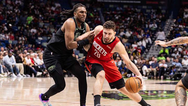 Mar 29, 2026; New Orleans, Louisiana, USA;  Houston Rockets center Alperen Sengun (28) dribbles against New Orleans Pelicans forward Kevon Looney (55) during the second half at Smoothie King Center. Mandatory Credit: Stephen Lew-Imagn Images