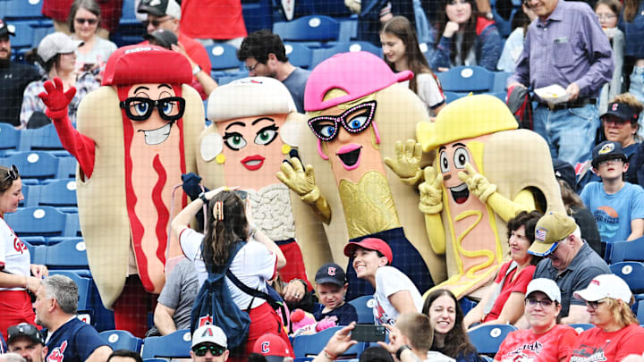 Jun 8, 2025; Cleveland, Ohio, USA; 
The Cleveland Guardians hot dog mascots pose for a photo with fans during the game between the Guardians and the Houston Astros at Progressive Field. Mandatory Credit: Ken Blaze-Imagn Images