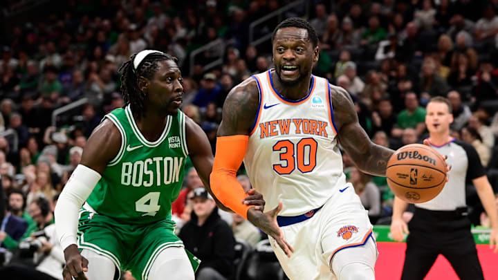 Dec 8, 2023; Boston, Massachusetts, USA;  New York Knicks forward Julius Randle (30) moves to the basket  while being defended by Boston Celtics guard Jrue Holiday (4) during the first half at TD Garden. Mandatory Credit: Eric Canha-Imagn Images
