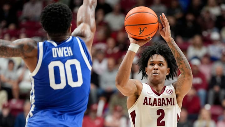 Jan 3, 2026; Tuscaloosa, AL, USA; Alabama guard Aden Holloway (2) nails a deep three pointer as he is defended by Kentucky guard Otega Oweh (00) at Coleman Coliseum. Alabama downed Kentucky 89-74. Mandatory Credit: Gary Cosby Jr.-Tuscaloosa News