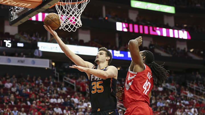 Phoenix Suns forward Dragan Bender shoots the ball against Houston Rockets center Nene Hilario. Phoenix Suns forward Dragan Bender shoots the ball against Houston Rockets center Nene Hilario.