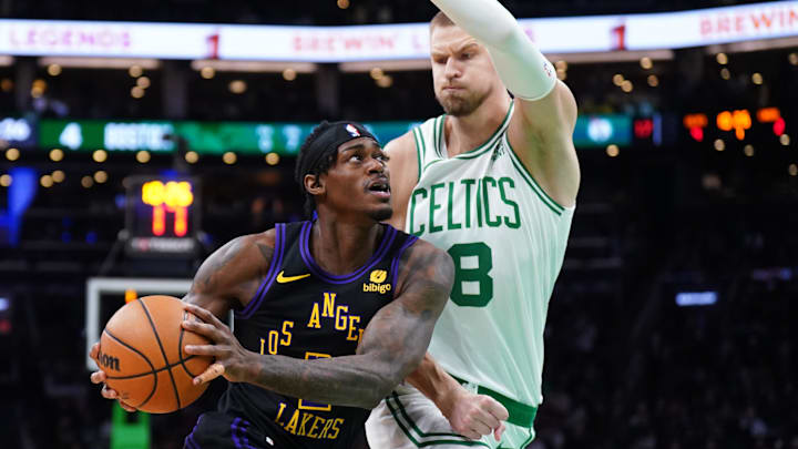 Feb 1, 2024; Boston, Massachusetts, USA; Los Angeles Lakers forward Jarred Vanderbilt (2) drives the ball against Boston Celtics center Kristaps Porzingis (8) in the first quarter at TD Garden. Mandatory Credit: David Butler II-Imagn Images