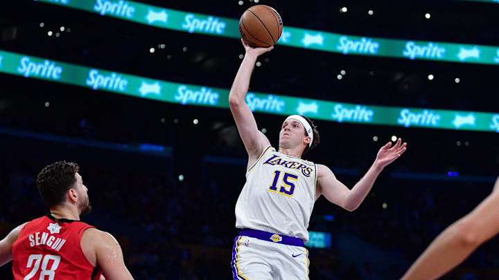 Dec 25, 2025; Los Angeles, California, USA; Los Angeles Lakers guard Austin Reaves (15) shoots against Houston Rockets center Alperen Sengun (28) during the first half at Crypto.com Arena. Mandatory Credit: Gary A. Vasquez-Imagn Images