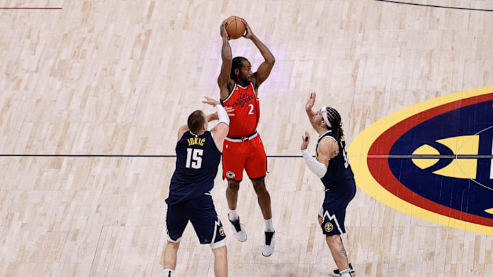 Apr 21, 2025; Denver, Colorado, USA; Los Angeles Clippers forward Kawhi Leonard (2) controls the ball as Denver Nuggets center Nikola Jokic (15) and forward Aaron Gordon (32) defend in the fourth quarter during game two of first round for the 2025 NBA Playoffs at Ball Arena. Mandatory Credit: Isaiah J. Downing-Imagn Images