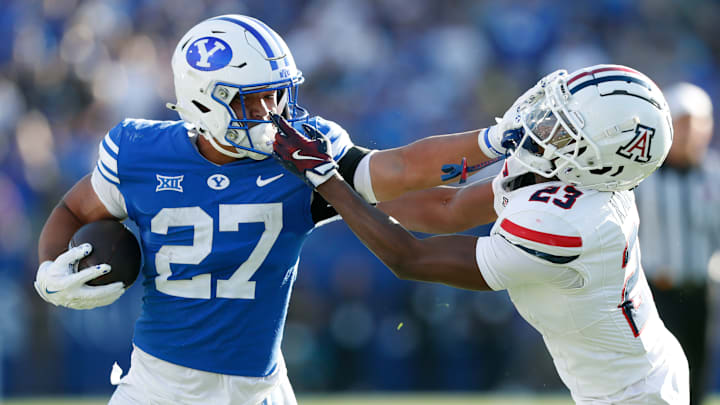 BYU RB LJ Martin stiff arms an Arizona defender as the Cougars handled the Wildcats.