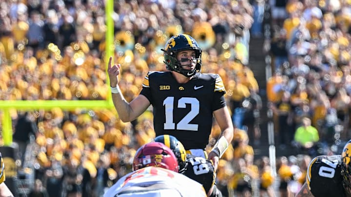 Sep 7, 2024; Iowa City, Iowa, USA; Iowa Hawkeyes quarterback Cade McNamara (12) controls the offense during the first quarter against the Iowa State Cyclones at Kinnick Stadium. Mandatory Credit: Jeffrey Becker-Imagn Images