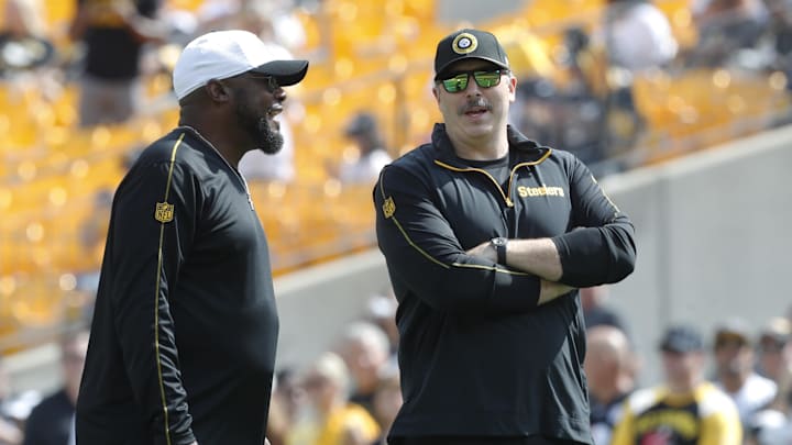 Sep 22, 2024; Pittsburgh, Pennsylvania, USA;  Pittsburgh Steelers head coach Mike Tomlin (left) and offensive coordinator Arthur Smith (right) talk on the field before the game against the Los Angeles Chargers at Acrisure Stadium. Mandatory Credit: Charles LeClaire-Imagn Images