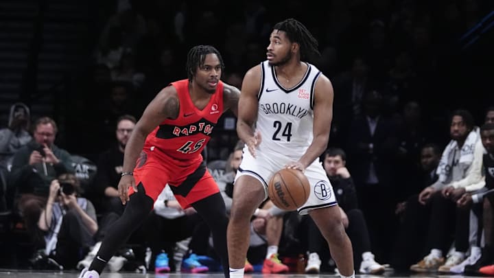 Oct 18, 2024; Brooklyn, New York, USA; Brooklyn Nets small guard Cam Thomas (24) dribbles the ball against Toronto Raptors forward Bruno Fernando (24) during the second half at Barclays Center. Mandatory Credit: Gregory Fisher-Imagn Images