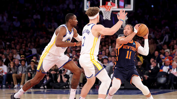 New York Knicks guard Jalen Brunson (11) controls the ball against Golden State Warriors forward Jonathan Kuminga (00) and guard Brandin Podziemski (2) during the first quarter at Madison Square Garden. Mandatory Credit: Brad Penner-Imagn Images