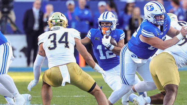 Oct 17, 2026; Provo, Utah, USA; Brigham Young Cougars running back Preston Rex (12) runs the ball against Notre Dame Fighting Irish linebacker Drayk Bowen (34) during the first half at LaVell Edwards Stadium. Mandatory Credit: Rob Gray-Imagn Images Oct 17, 2026; Provo, Utah, USA; Brigham Young Cougars running back Preston Rex (12) runs the ball against Notre Dame Fighting Irish linebacker Drayk Bowen (34) during the first half at LaVell Edwards Stadium. Mandatory Credit: Rob Gray-Imagn Images