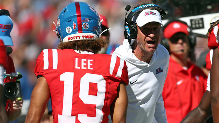 Oct 11, 2025; Oxford, Mississippi, USA; Mississippi Rebels head coach Lane Kiffin reacts with wide receiver Cayden Lee (19) during the fourth quarter at Vaught-Hemingway Stadium. Mandatory Credit: Petre Thomas-Imagn Images