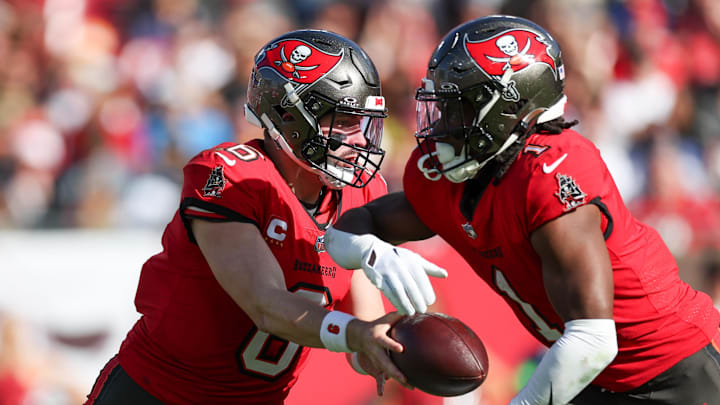 Dec 31, 2023; Tampa, Florida, USA;  Tampa Bay Buccaneers quarterback Baker Mayfield (6) hands off to Rachaad White (1). 