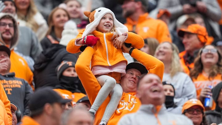 A young fan is raised for the Simba cam during a NCAA football game between Tennessee and Vanderbilt at Neyland Stadium in Knoxville, Tenn., on Nov. 29, 2025.