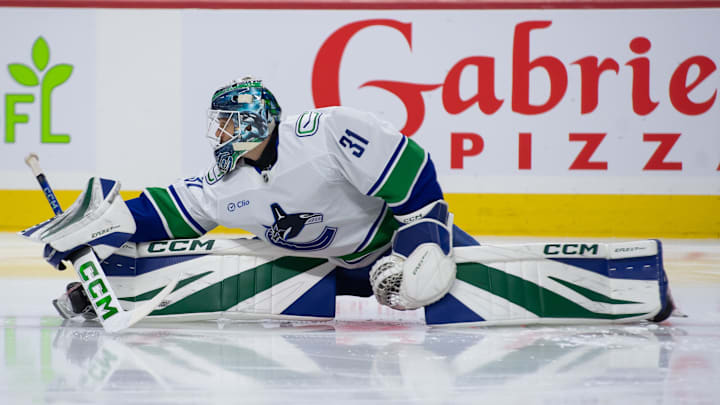 Nov 23, 2024; Ottawa, Ontario, CAN; Vancouver Canucks goalie Arturs Silovs (31) stretches during warmup prior to game against the Ottawa Senators at the Canadian Tire Centre. Mandatory Credit: Marc DesRosiers-Imagn Images