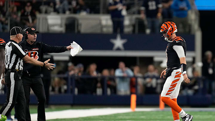 Cincinnati Bengals head coach Zac Taylor argues with a referee as Cincinnati Bengals quarterback Joe Burrow (9) walks off to the bench as the game was tied with the Dallas Cowboys during Monday Night Football at AT&T Stadium in Arlington,Texas on Monday, December 9, 2024. The Bengals went on to win 27-20.