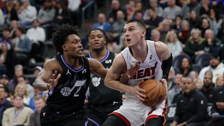 Jan 9, 2025; Salt Lake City, Utah, USA;  Miami Heat guard Tyler Herro (14) tries to get away from Utah Jazz guard Collin Sexton (2) during the first quarter at Delta Center. Mandatory Credit: Chris Nicoll-Imagn Images