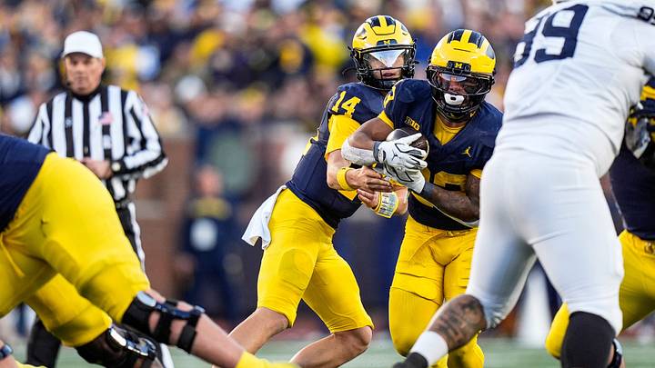 Michigan quarterback Tommy Carr (14) hands the ball to running back Jordan Marshall (23) against Penn State during the second half at Michigan Stadium in Ann Arbor on Saturday, Oct. 17, 2026.