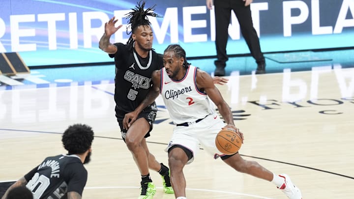 Jan 29, 2025; San Antonio, Texas, USA;  LA Clippers forward Kawhi Leonard (2) dribbles past San Antonio Spurs guard Stephon Castle (5) in the first half at Frost Bank Center. Mandatory Credit: Daniel Dunn-Imagn Images