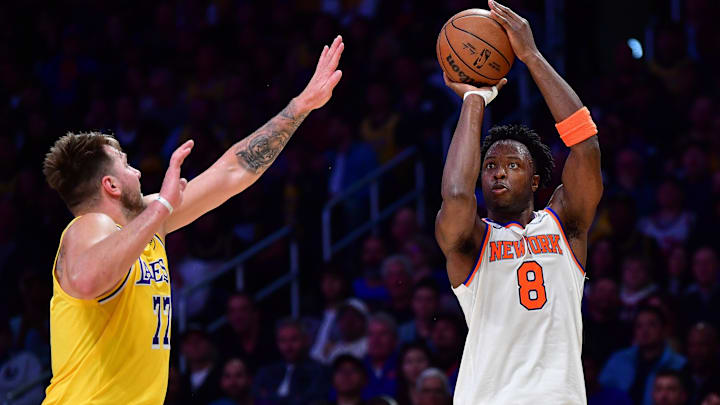 Mar 6, 2025; Los Angeles, California, USA; New York Knicks forward OG Anunoby (8) shoots a three point basket against Los Angeles Lakers guard Luka Doncic (77) during the first half at Crypto.com Arena. Mandatory Credit: Gary A. Vasquez-Imagn Images