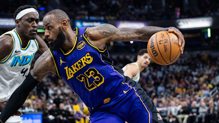 Mar 26, 2025; Indianapolis, Indiana, USA; Los Angeles Lakers forward LeBron James (23) dribbles the ball while Indiana Pacers forward Pascal Siakam (43) defends in the second half at Gainbridge Fieldhouse. Mandatory Credit: Trevor Ruszkowski-Imagn Images