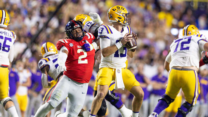 Oct 12, 2024; Baton Rouge, Louisiana, USA;  Mississippi Rebels defensive tackle Walter Nolen (2) reaches to knock the ball loose from LSU Tigers quarterback Garrett Nussmeier (13) during the first half at Tiger Stadium. Mandatory Credit: Stephen Lew-Imagn Images