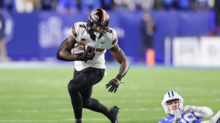 Oct 18, 2024; Provo, Utah, USA; Oklahoma State Cowboys running back Ollie Gordon II (0) runs for a catch for a touchdown against the Brigham Young Cougars during the first quarter at LaVell Edwards Stadium. Mandatory Credit: Rob Gray-Imagn Images