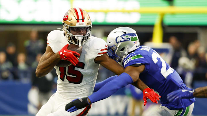 Oct 10, 2024; Seattle, Washington, USA; San Francisco 49ers wide receiver Jauan Jennings (15) runs for yards after the catch against Seattle Seahawks cornerback Tre Brown (22) during the second quarter at Lumen Field. Mandatory Credit: Joe Nicholson-Imagn Images
