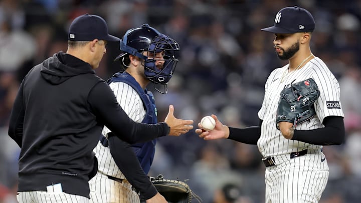 Apr 25, 2025; Bronx, New York, USA; New York Yankees manager Aaron Boone (17) takes the ball from relief pitcher Devin Williams (38) during a pitching change during the ninth inning against the Toronto Blue Jays at Yankee Stadium. Mandatory Credit: Brad Penner-Imagn Images