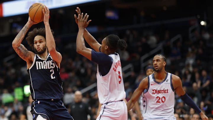 Dec 5, 2024; Washington, District of Columbia, USA; Dallas Mavericks center Dereck Lively II (2) passes the ball as Washington Wizards guard Bub Carrington (8) defends in the second quarter at Capital One Arena. Mandatory Credit: Geoff Burke-Imagn Images