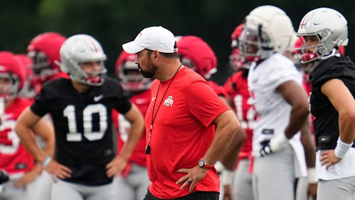 Ohio State Buckeyes head coach Ryan Day watches players warm up during the first football practice of the season at the Woody Hayes Athletic Center on July 31, 2025.