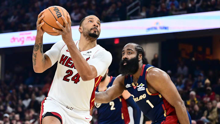 Mar 27, 2026; Cleveland, Ohio, USA; Miami Heat guard Norman Powell (24) drives to the basket against Cleveland Cavaliers guard James Harden (1) during the first half at Rocket Arena. Mandatory Credit: Ken Blaze-Imagn Images