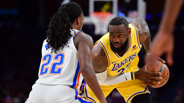 Mar 4, 2024; Los Angeles, California, USA; Los Angeles Lakers forward LeBron James (23) controls the ball against Oklahoma City Thunder guard Cason Wallace (22) during the first half at Crypto.com Arena. Mandatory Credit: Gary A. Vasquez-Imagn Images