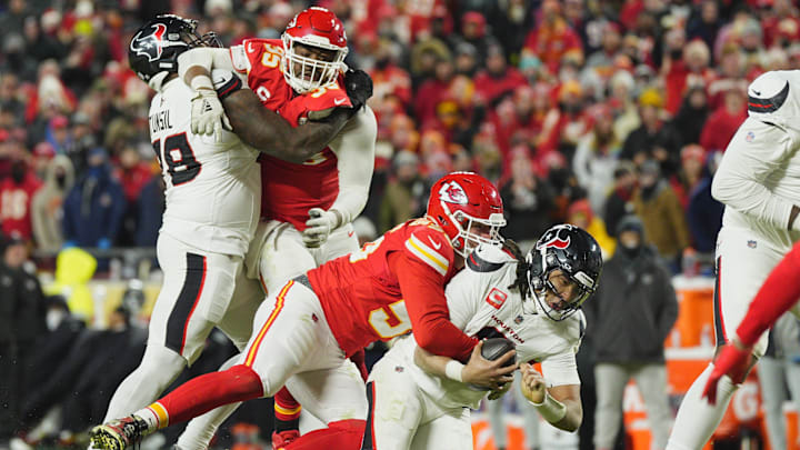 Jan 18, 2025; Kansas City, Missouri, USA; Houston Texans quarterback C.J. Stroud (7) is sacked by Kansas City Chiefs defensive end George Karlaftis (56) during the fourth quarter of a 2025 AFC divisional round game at GEHA Field at Arrowhead Stadium. Mandatory Credit: Jay Biggerstaff-Imagn Images