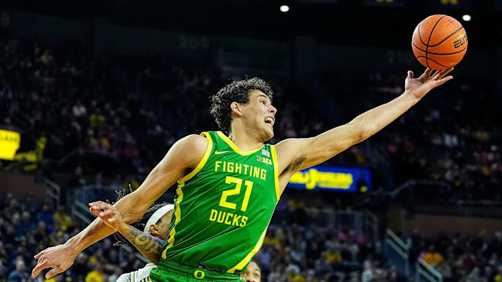 Oregon forward Brandon Angel (21) grabs a rebound against Michigan guard Roddy Gayle Jr. (11) during the first half at Crisler Center in Ann Arbor on Wednesday, Feb. 5, 2025.
