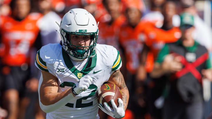 Sep 27, 2025; Stillwater, Oklahoma, USA; Baylor Bears running back Caden Knighten (22) runs the ball during the first half against the Oklahoma State Cowboys  at Boone Pickens Stadium. Mandatory Credit: William Purnell-Imagn Images