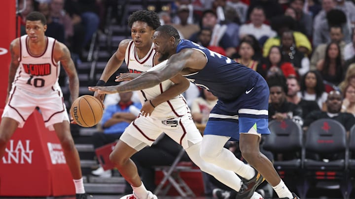 Dec 27, 2024; Houston, Texas, USA; Minnesota Timberwolves forward Julius Randle (30) attempts to control the ball away from Houston Rockets forward Amen Thompson (1) during the fourth quarter at Toyota Center. Mandatory Credit: Troy Taormina-Imagn Images