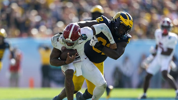 Dec 31, 2024; Tampa, FL, USA; Alabama Crimson Tide quarterback Jalen Milroe (4) is sacked by Michigan Wolverines defensive lineman Ike Iwunnah (92) in the third quarter during the ReliaQuest Bowl at Raymond James Stadium. Mandatory Credit: Nathan Ray Seebeck-Imagn Images Dec 31, 2024; Tampa, FL, USA; Alabama Crimson Tide quarterback Jalen Milroe (4) is sacked by Michigan Wolverines defensive lineman Ike Iwunnah (92) in the third quarter during the ReliaQuest Bowl at Raymond James Stadium. Mandatory Credit: Nathan Ray Seebeck-Imagn Images