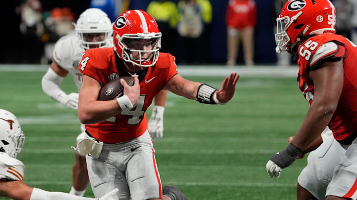Georgia quarterback Gunner Stockton (14) runs the ball during the second half of the SEC championship game against Texas in Atlanta, on Saturday, Dec. 7, 2024. Georgia quarterback Gunner Stockton (14) runs the ball during the second half of the SEC championship game against Texas in Atlanta, on Saturday, Dec. 7, 2024.