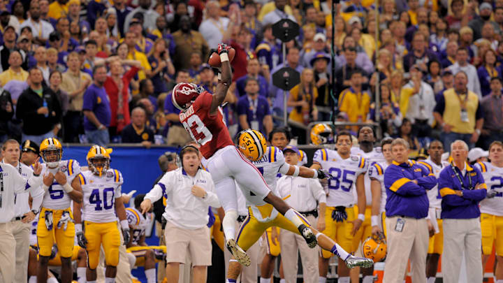 Jan 9, 2012; New Orleans, LA, USA; Alabama Crimson Tide wide receiver Kevin Norwood (83) makes a catch over LSU Tigers cornerback Tyrann Mathieu (7) during the first half of the 2012 BCS National Championship game at the Mercedes-Benz Superdome.  Mandatory Credit: John David Mercer-Imagn Images
