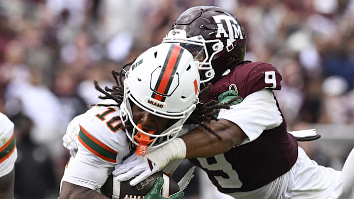 Dec 20, 2025; College Station, TX, USA; Miami Hurricanes wide receiver Malachi Toney (10) is tackled by Texas A&M Aggies defensive end Cashius Howell (9) during the second half of the first round game of the CFP National Playoff at Kyle Field. Mandatory Credit: Jerome Miron-Imagn Images