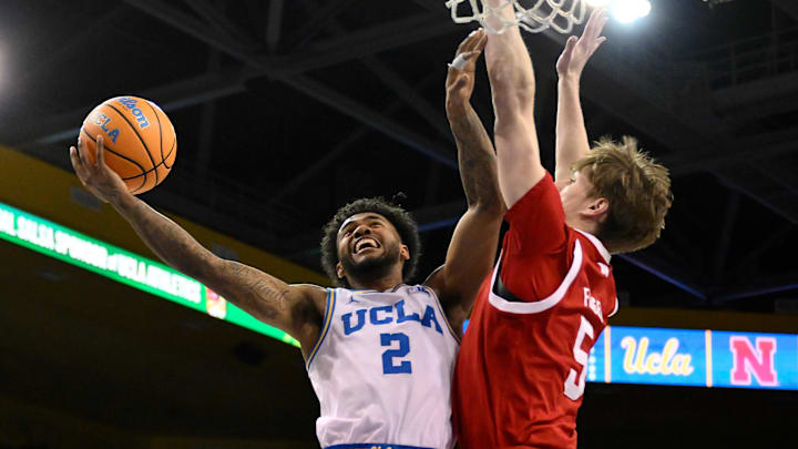 Mar 3, 2026; Los Angeles, California, USA; UCLA Bruins guard Donovan Dent (2) drives to the basket as Nebraska Cornhuskers forward Braden Frager (5) tries to defend during the first half at Pauley Pavilion presented by Wescom Financial. Mandatory Credit: Robert Hanashiro-Imagn Images