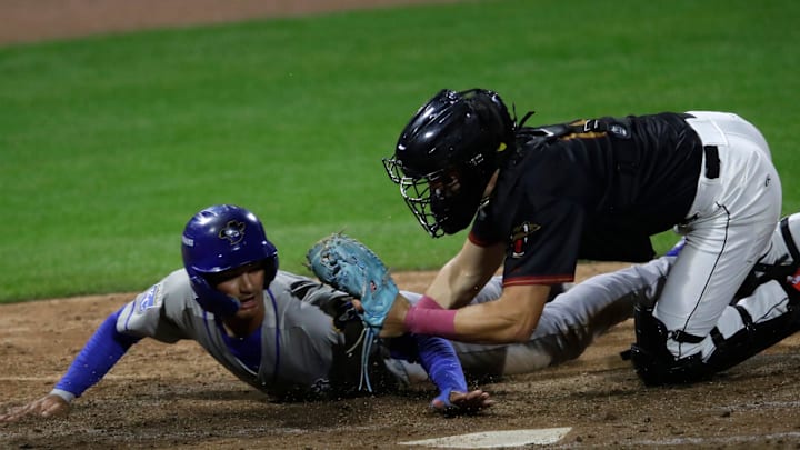 Wisconsin Timber Rattlers' Marco Dinges (8) tags out Quad Cities River Bandits' Sam Kulasingam (8) at home plate Wednesday, August 27, 2025, at Neuroscience Group Field at Fox Cities Stadium in Grand Chute, Wisconsin. Quad City won 9-5.